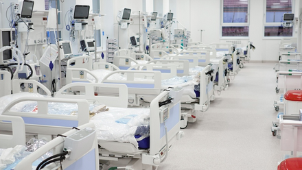 A row of empty hospital beds
