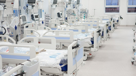 A row of empty hospital beds