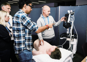 Three men and a woman look at an ultrasound image