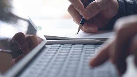 A person typing on a laptop