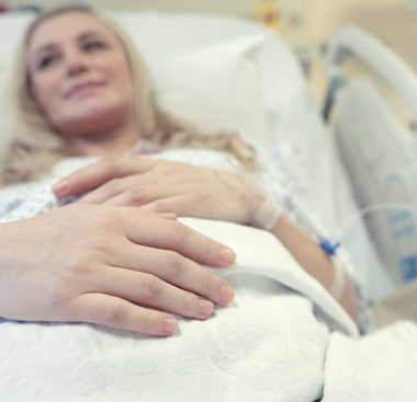 A pregnant woman lying in a hospital bed