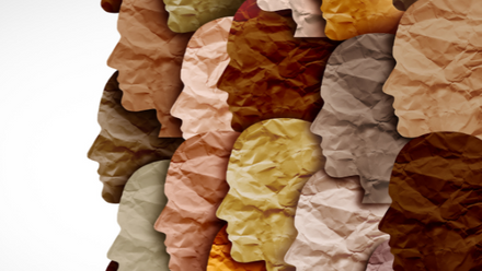 An illustration of heads of many different shades which appear to be made of crinkled paper.