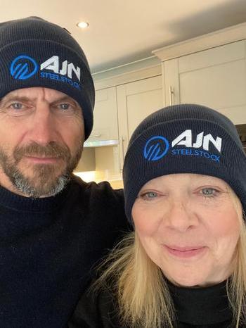 A man and a woman wearing black beanies